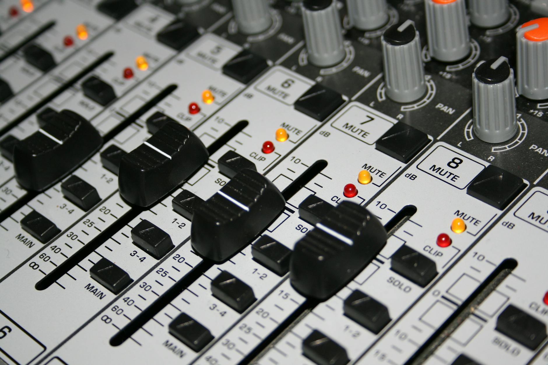 Audio mixing console with faders showing audio codec processing chain